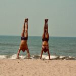 Scarlett & Ferdinand handstands on the beach in Goa