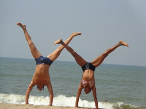 ashtanga yoga teacher training teachers play handstands on the beach